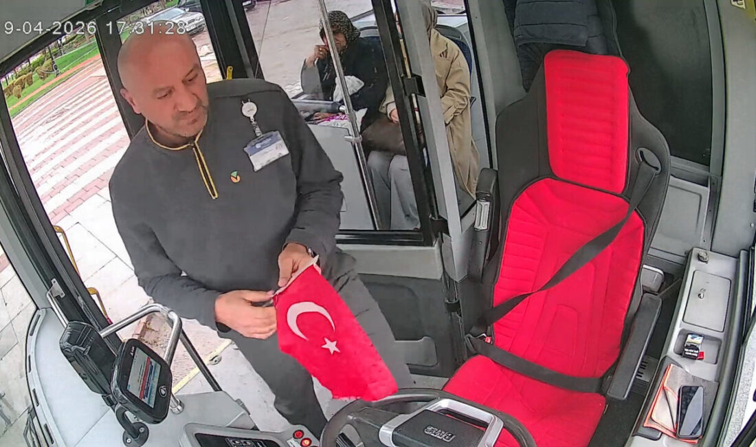 Malatya’da otobüs şoförü Şenkan Arıkan, rüzgarla yola düşen Türk Bayrağı’nı